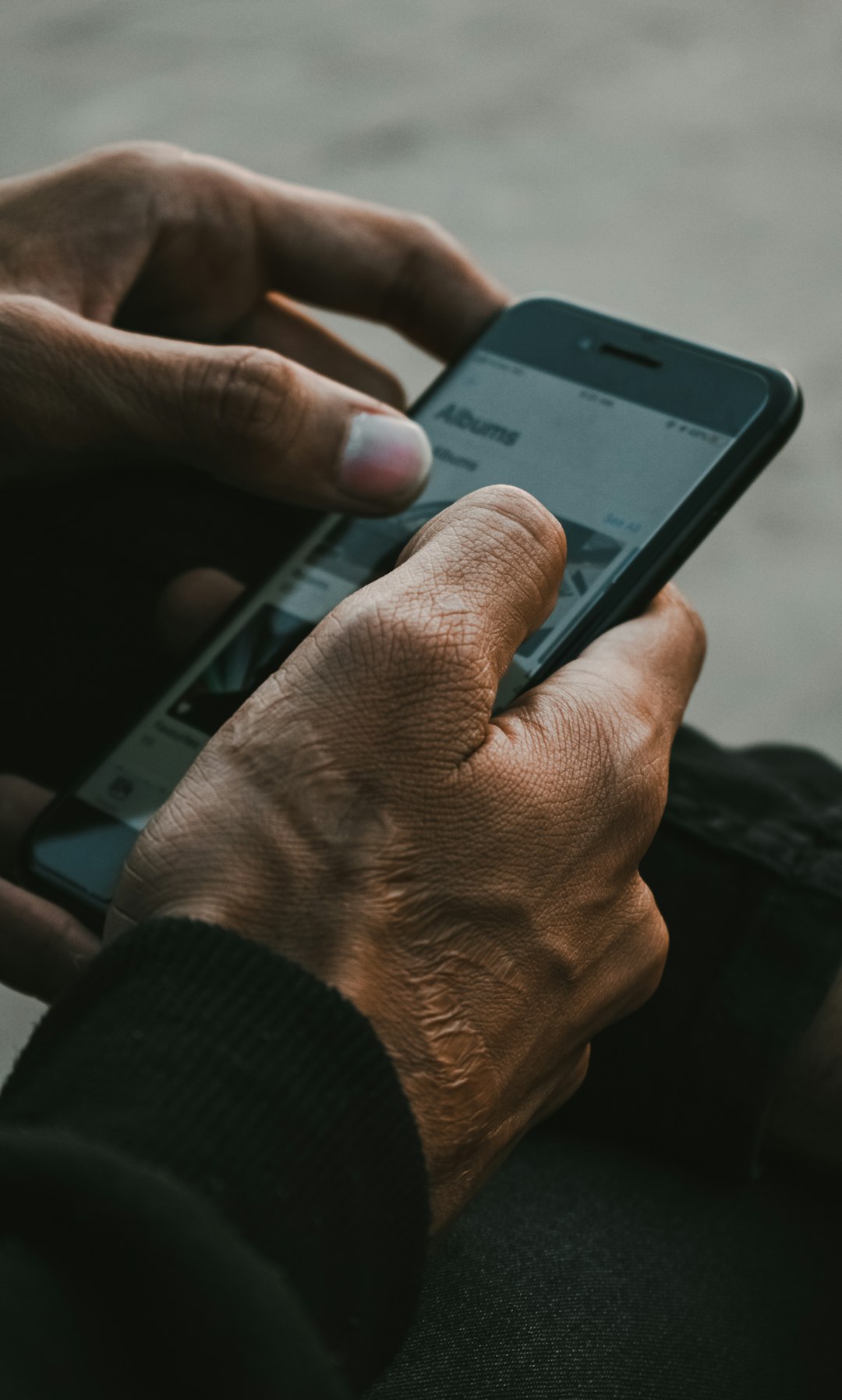 A person goes through a lot in life and usually, we can see these experiences in the hands of the person. This photograph shows a man going down the lane of memories stored in his phone.